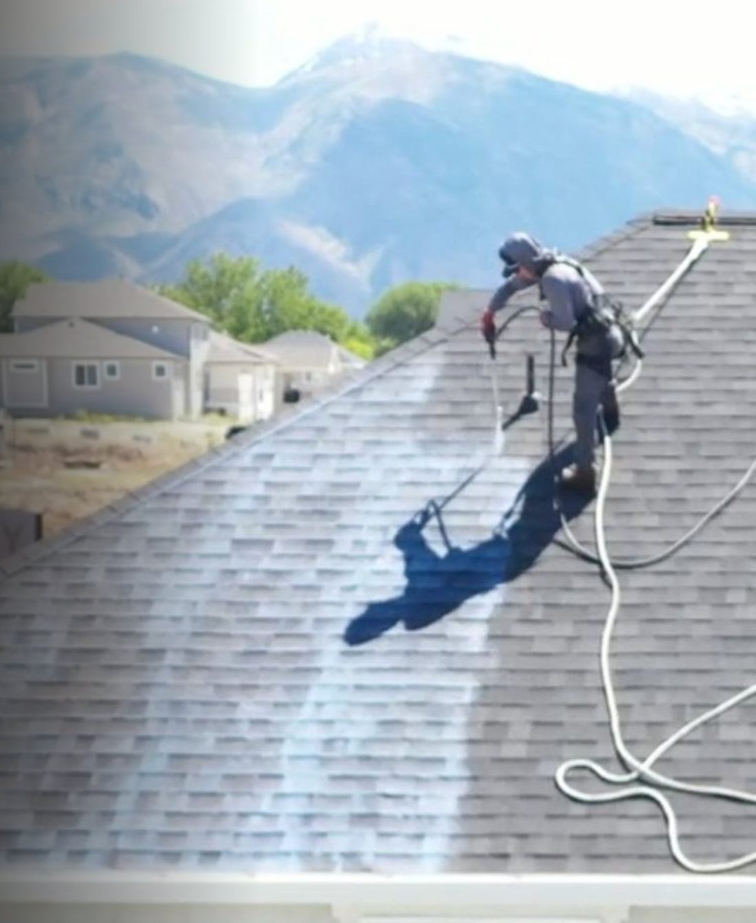 mantl crew member applying coating to an asphalt shingle roof